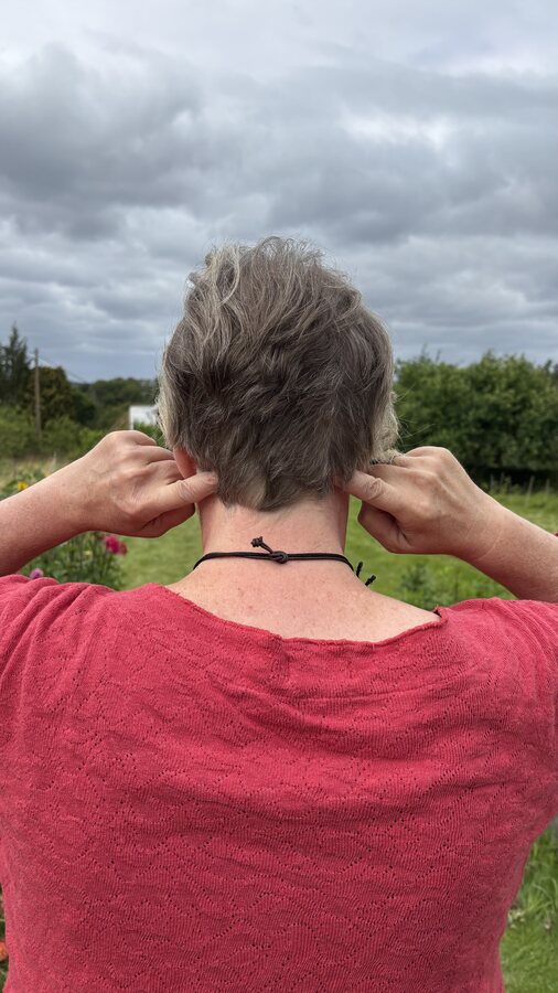 Nicola drückt mit den Fingern die Akupressur Gallenblase 20 im Nacken